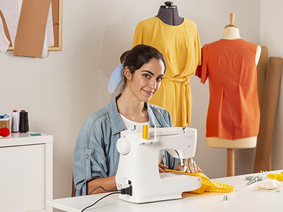 medium-shot-smiley-woman-sewing-with-machine